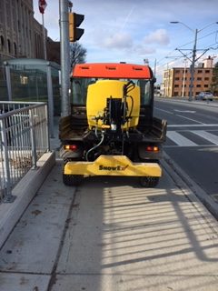 Yellow tractor in sidewalk